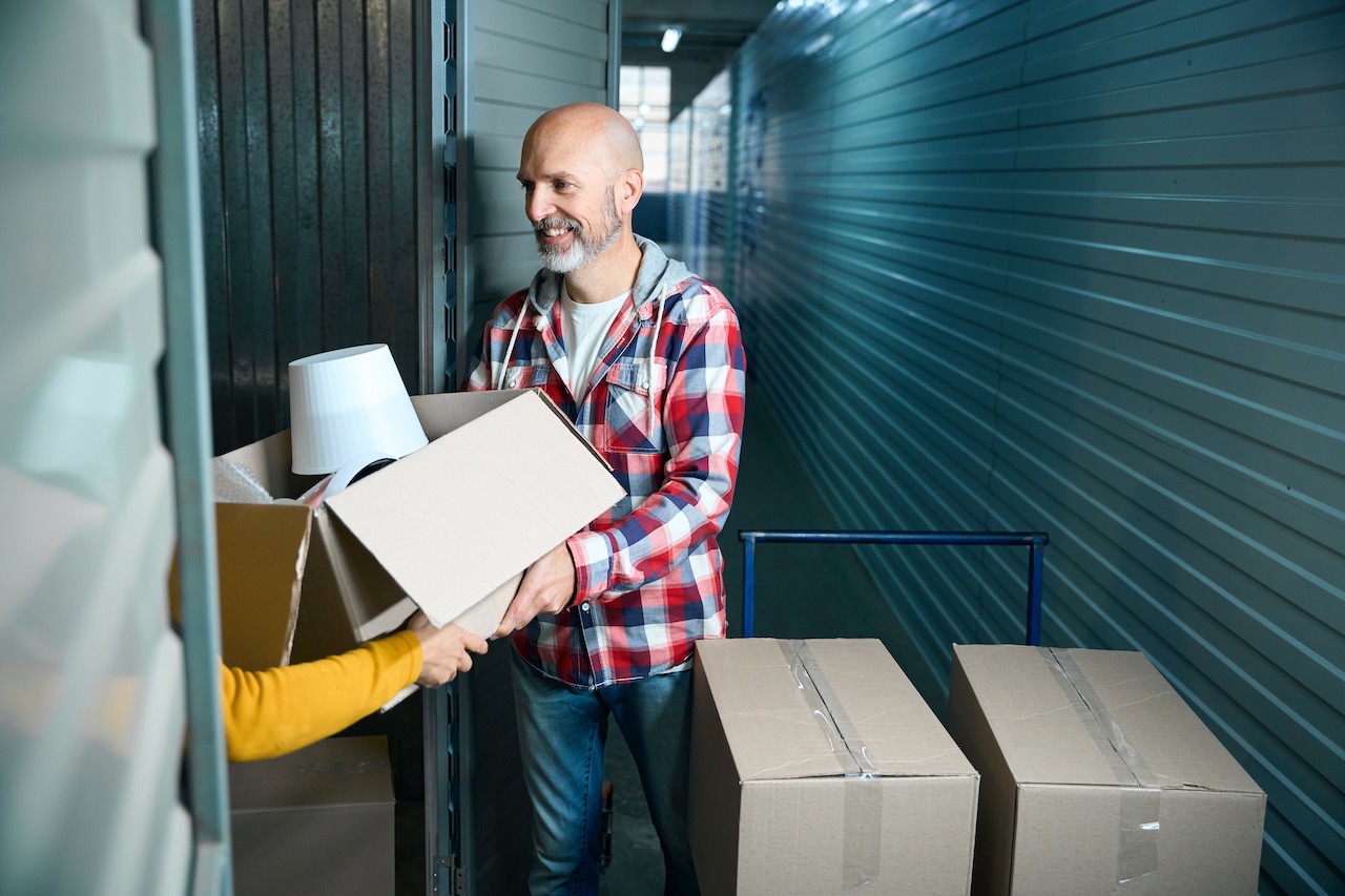 couple putting belongings in self storage unit